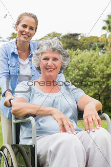 Smiling woman in wheelchair with her daughter