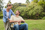 Smiling man in wheelchair talking with partner