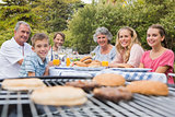Happy family having a barbecue in the park together