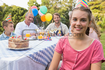 Little girl smiling at camera at her birthday party
