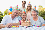 Cheeful family smiling at camera at birthday party