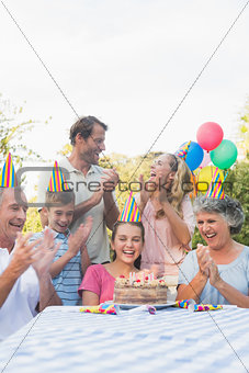 Cheerful extended family clapping for little girls birthday