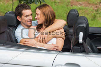 Couple in love cuddling in the backseat and chatting
