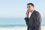 Pensive businessman on the phone