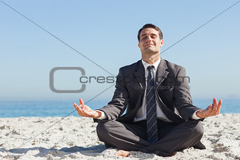 Young businessman sitting with legs crossed relaxing