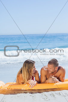 Cheerful cute couple in swimsuit relaxing together