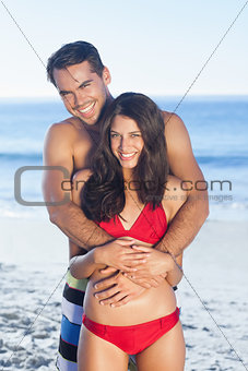 Happy couple in swimsuit hugging