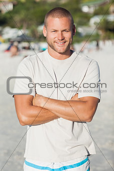 Handsome happy man in swimsuit and tshrt posing