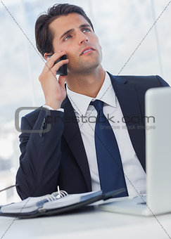 Thoughtful businessman having a phone call