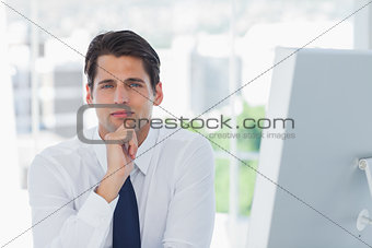 Thoughtful businessman posing looking at camera