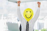 Yellow balloon with cheerful face replacing businessmans face