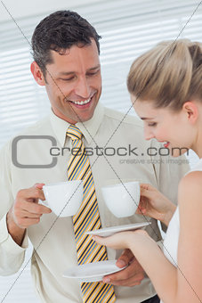 Stylish workmates drinking coffee together