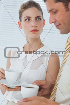 Attractive businesswoman looking at her colleague