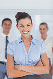 Smiling businesswoman posing with arms crossed