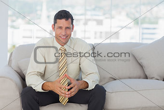 Self-confident businessman sitting on sofa