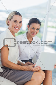 Cheerful attractive businesswomen working together