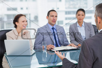 Work team interviewing experienced man