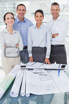 Happy architects posing while working together