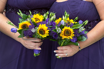 bridesmaids in purple with sunflower bouquets