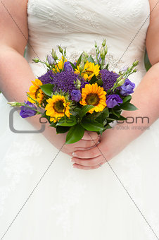 bride holding a sunflower bouquet
