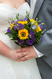 bride and groom holding a wedding bouquet