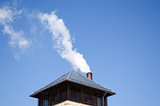 modern tin roof smoke rise chimney pipe blue sky 
