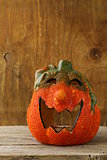 Halloween pumpkin Jack O'Lantern on a wooden background