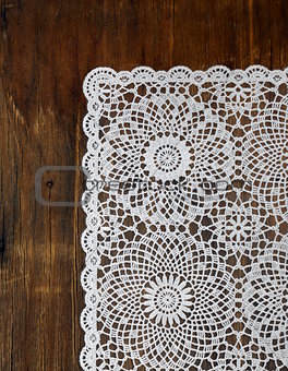 wooden background with white lace napkin