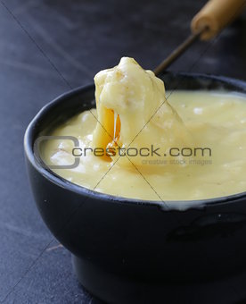 cheese fondue - piece of bread (croutons) in a liquid cheese