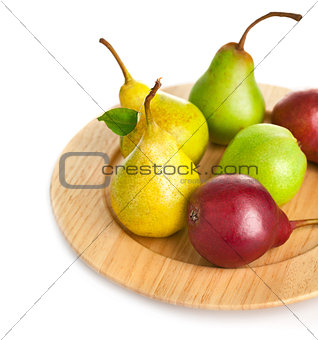 fresh pears on the wooden plate