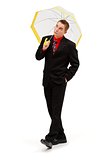 Joyful businessman walking with umbrella