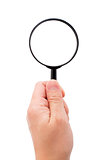 Hand holding magnifying glass