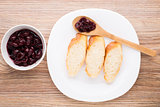 Slices of baguette with cherry jam