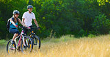 Young Happy Couple Riding Mountain Bikes Outdoor