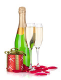 Two champagne glasses, christmas decor and rose petals