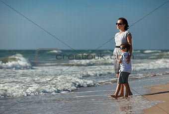 Mother and her little son enjoying beach