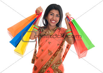 Indian woman in sari dress holding shopping bags