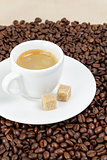 fine espresso in cup on coffee beans