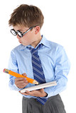 Schoolboy wearing glasses holding book and pencil and looking si