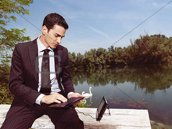 businessman using laptop outdoors b