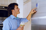 man looking on refrigerator
