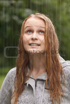 Girl enjoying rain in the park.
