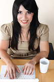 Closeup of woman working at desk on laptop