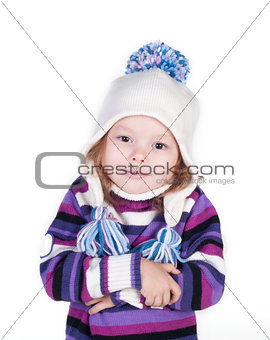 Smiling girl in winter clothes who is cold