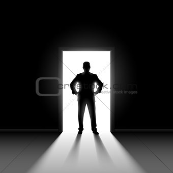 Silhouette of man standng in doorway. 