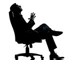 one business man sitting in armchair relaxing thinking silhouett