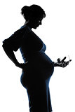 pregnant woman portrait holding baby bottle