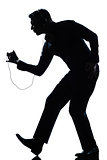 silhouette man full length dancing happy listening to music