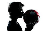 one young teenager boy or girl silhouette kissing soccer footbal