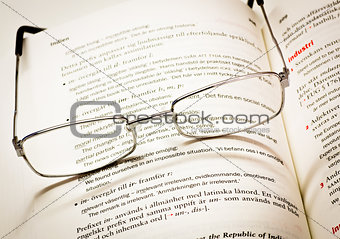 Reading glasses and dictionary
